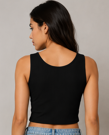 Woman wearing a black tank top against a gray background