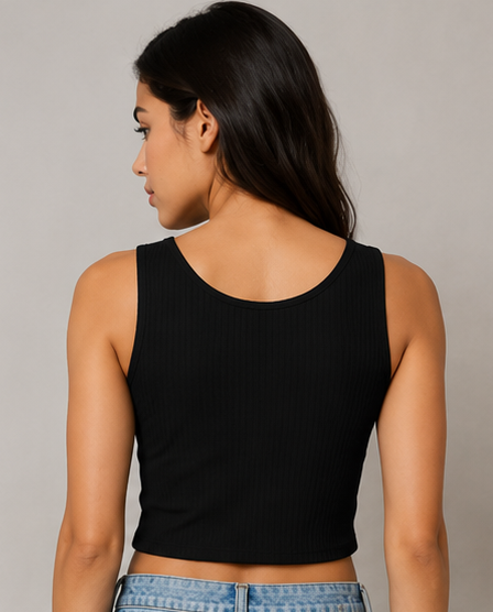 Woman wearing a black tank top against a gray background