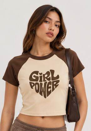 Woman wearing a 'Girl Power' t-shirt with a plain background